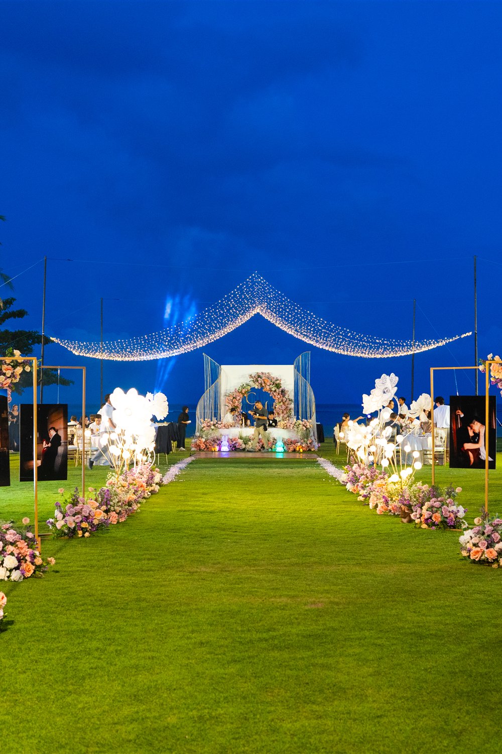 Outdoor celebration decor in Batam with a floral aisle and canopy lights