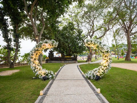 Garden aisle framed by a circular floral installation from the CITTA heritage archive
